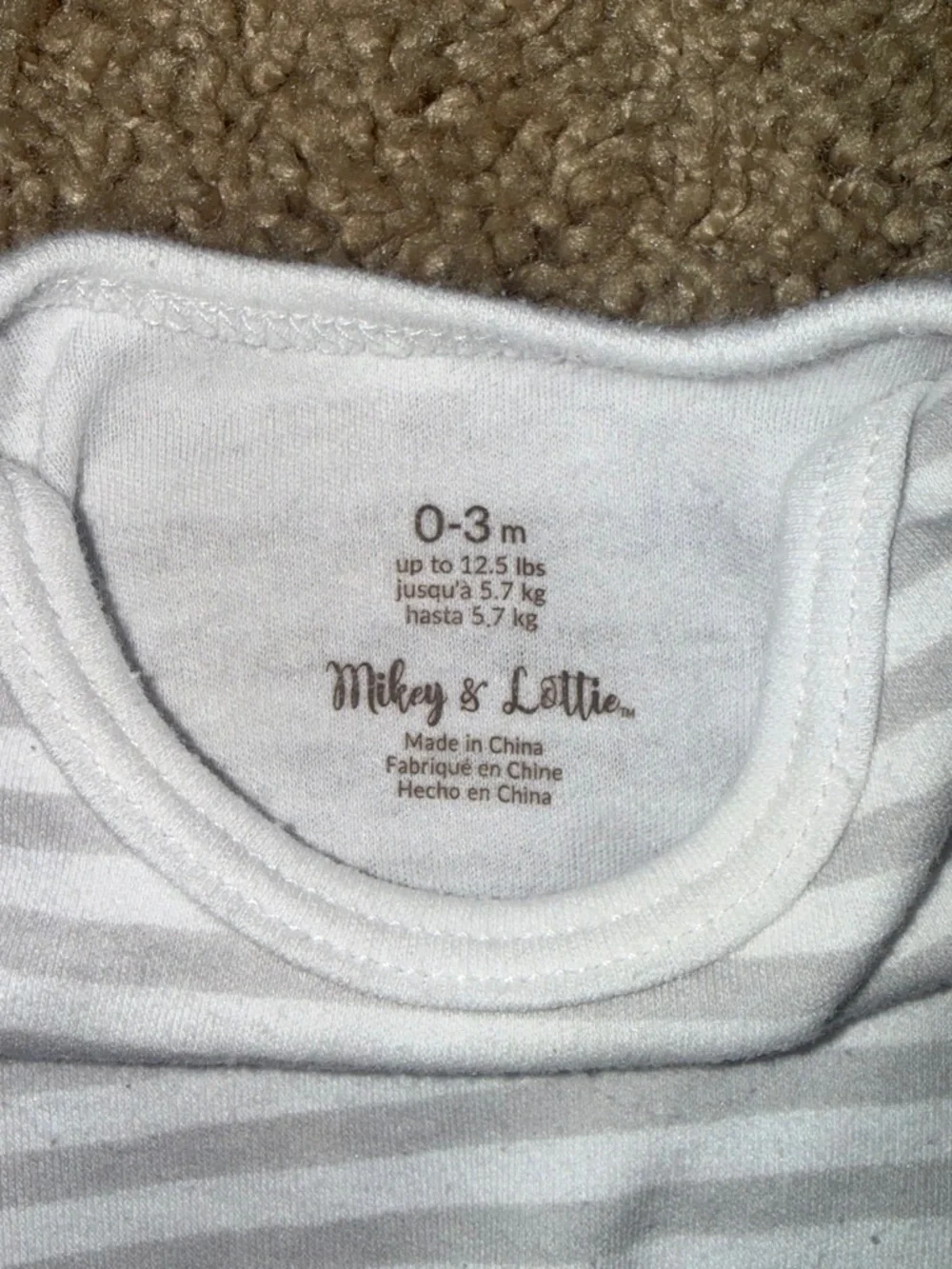 white and yellow striped baby onesies